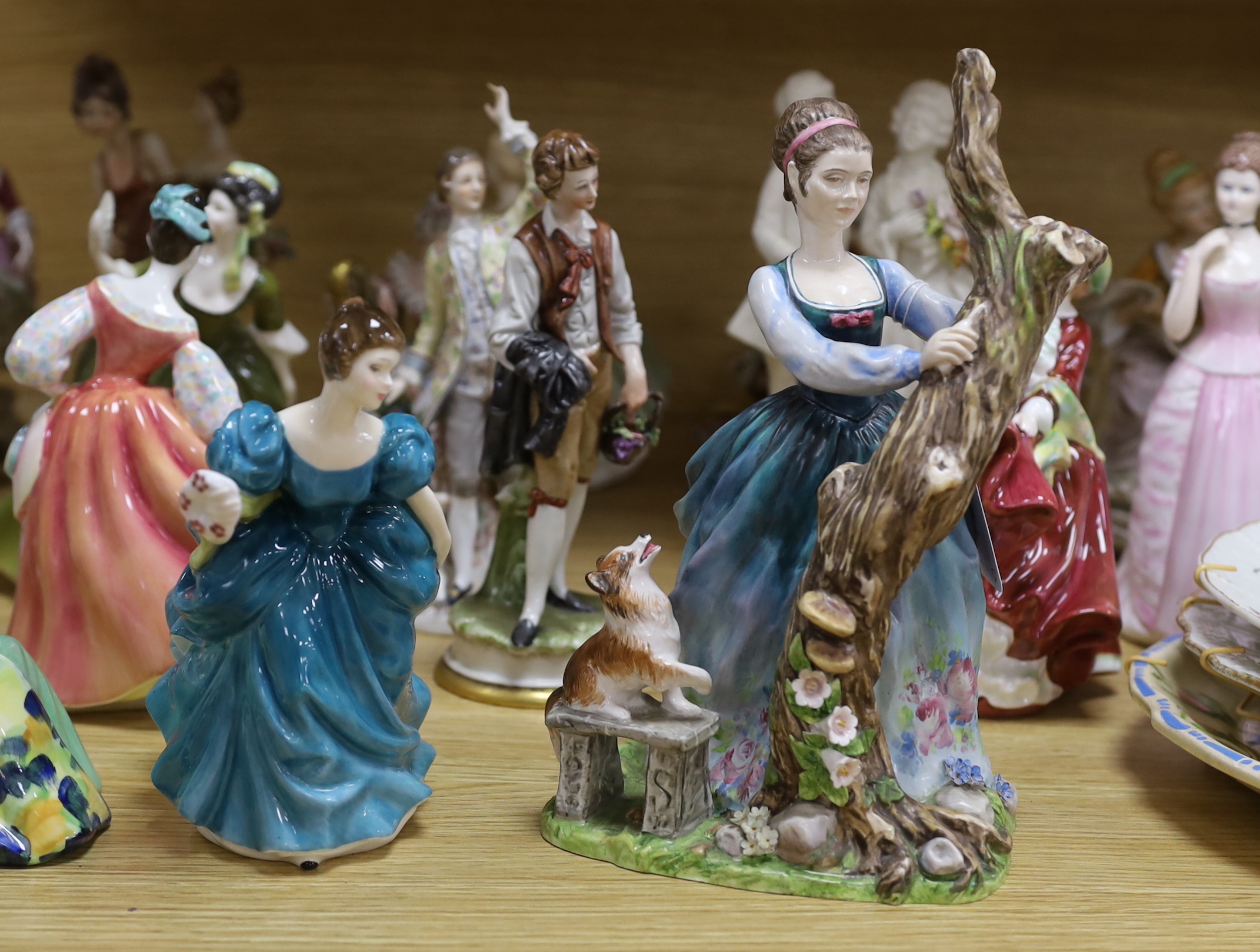 A collection of various porcelain figures including Coalport, Doulton etc. and two dessert plates